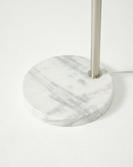 The round white marble base seen close with the nickel pole rising from it