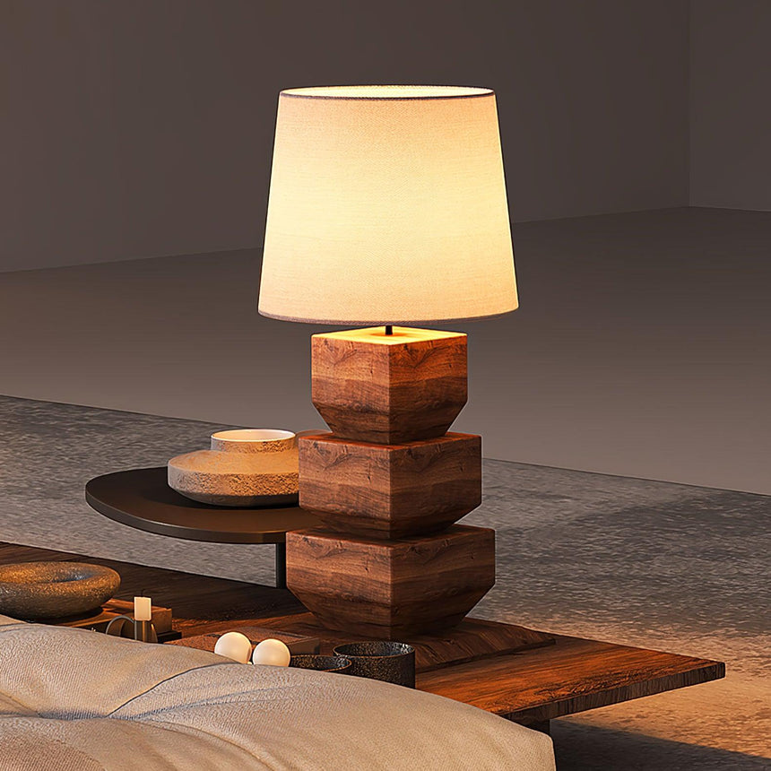 Tall table lamp lit on a low wooden table in a warm living room
