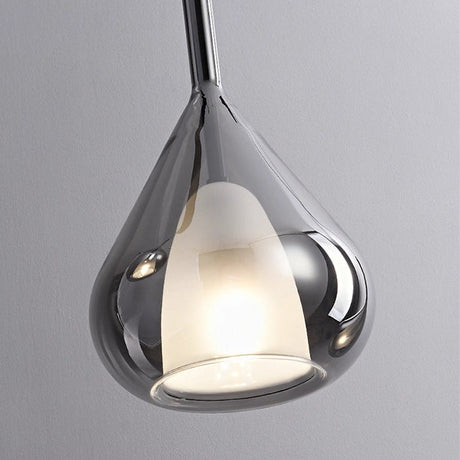 Close view of the lit teardrop with the inner opal cup showing through the glass