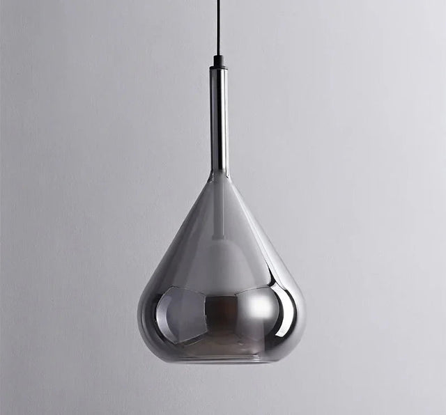A smoked glass teardrop shade hanging alone on a slim black cord