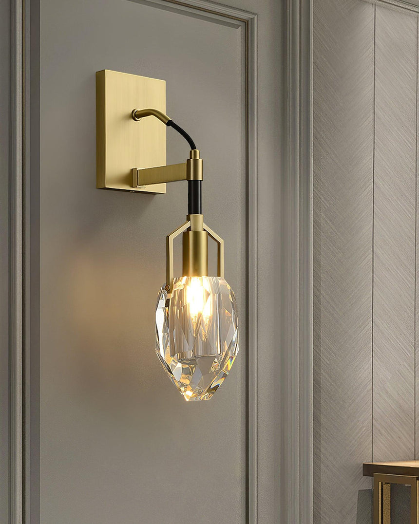 The crystal drop lit beside a paneled doorway in a hallway