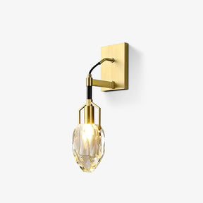 Brass wall sconce with a black cord and a faceted crystal drop in a slim brass cage