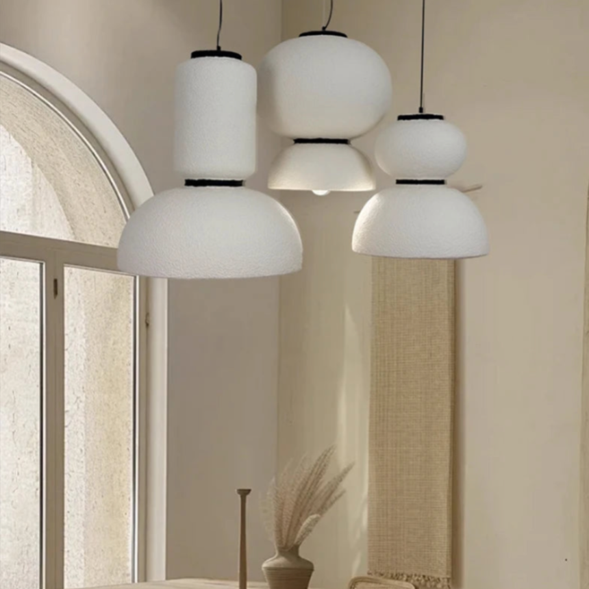 Textured pendants in a room with a plaster arch