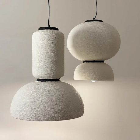 Column and dome pendant lit against a pale wall