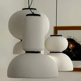 Two textured white pendants beside a framed print