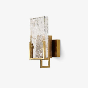 Wall sconce with a thick textured crystal glass panel held in a brass frame