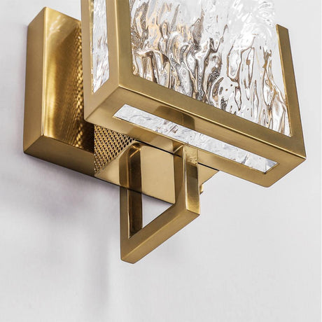 Close view of the brass frame corner around the glass panel