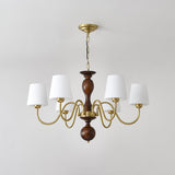 The turned walnut column with its ball finial and brass collar