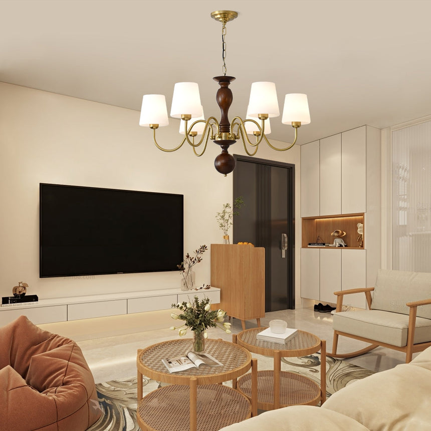 Chandelier lit in a living room above a bean bag chair and a table