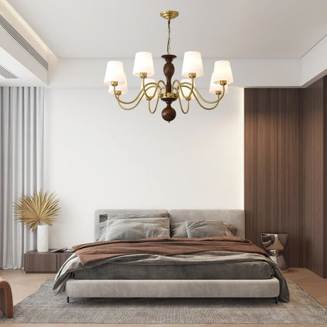 The cones lit above a low bed with dried grasses in a vase beside