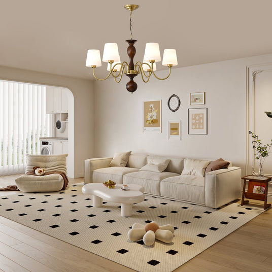 The fitting lit above a curved sofa on a patterned rug