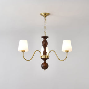 Three light chandelier with white fabric cones on a walnut column