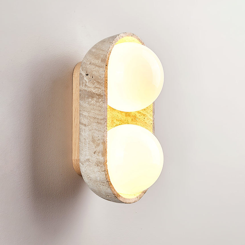 The short shell lit with two orbs glowing inside the carved stone rim