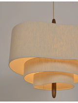 Two tier drum shade lit on a plain background