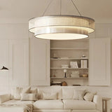 Tiered drum pendant light above white shelving in a dining area