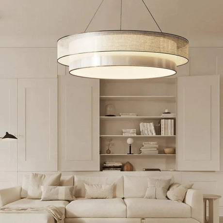 Tiered drum pendant light above white shelving in a dining area