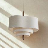 Two tier drum shade with sunlight falling across the wall behind it