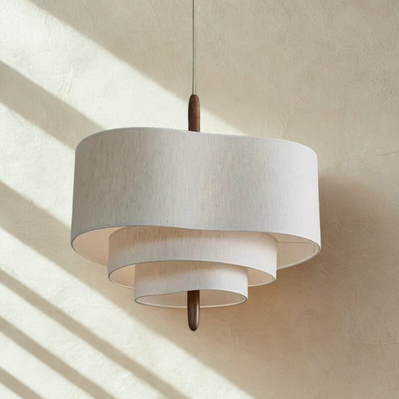Two tier drum shade with sunlight falling across the wall behind it