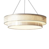 Two tier beige fabric drum pendant light on a plain background