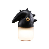 Black touch control bedside lamp lit, seen at an angle