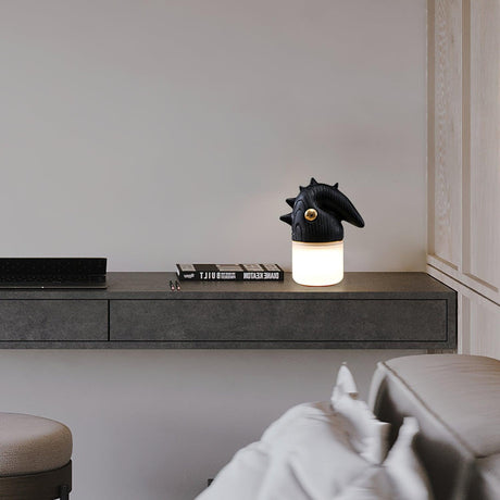 Touch control bedside lamp lit on a concrete ledge in a bedroom