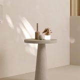 Touch control bedside lamp lit on a pale round table in sunlight