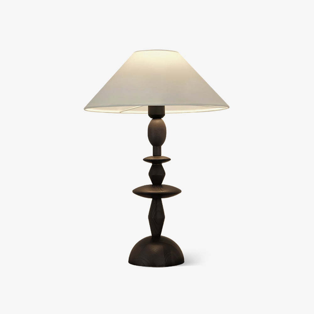 Traditional table lamp with a turned spindle base and a wide linen shade