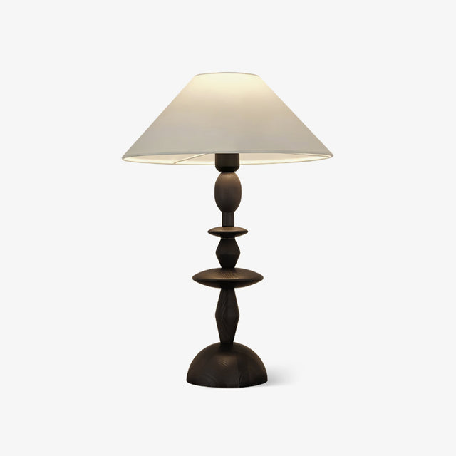 Traditional table lamp with a turned spindle base and a wide linen shade