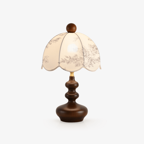 Table lamp with a scalloped printed dome shade on a turned walnut base