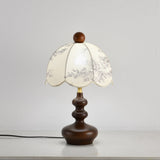 Scalloped toile shade lamp unlit seen from a slight angle