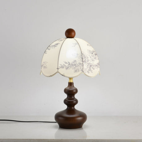 Scalloped toile shade lamp unlit seen from a slight angle