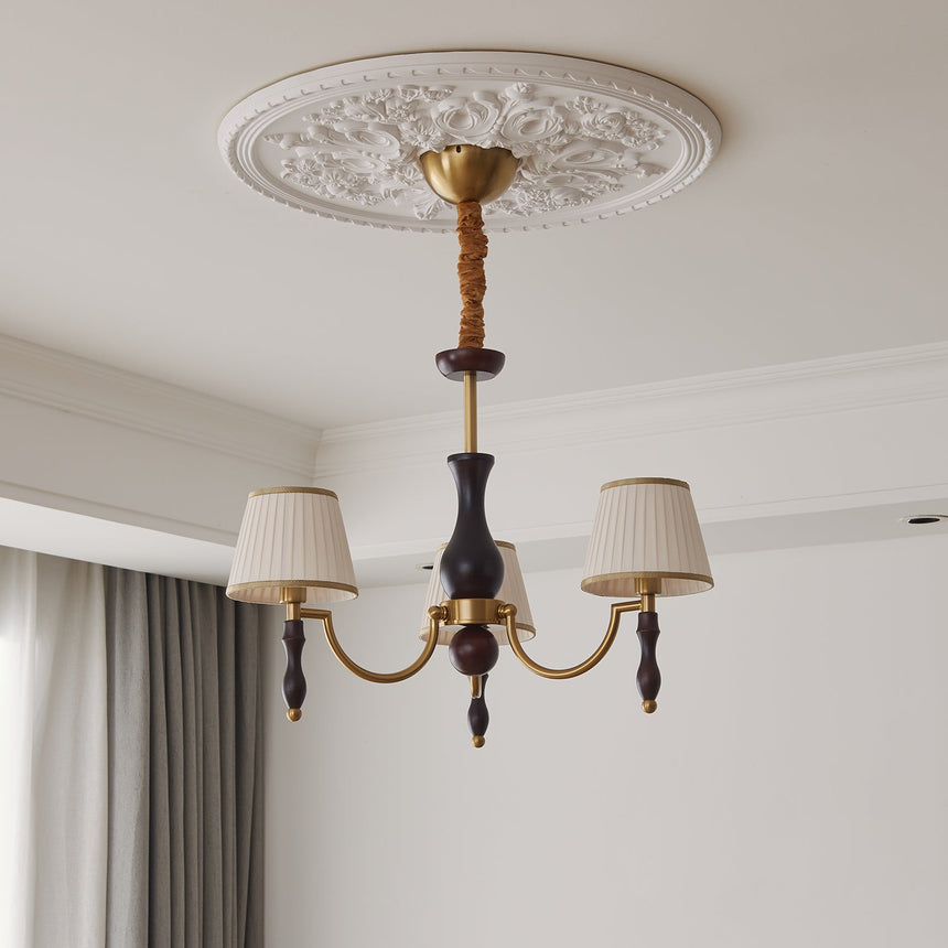 The walnut column and the gold collar the arms spring from