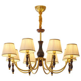 The eight light build lit warm with pleated shades all round
