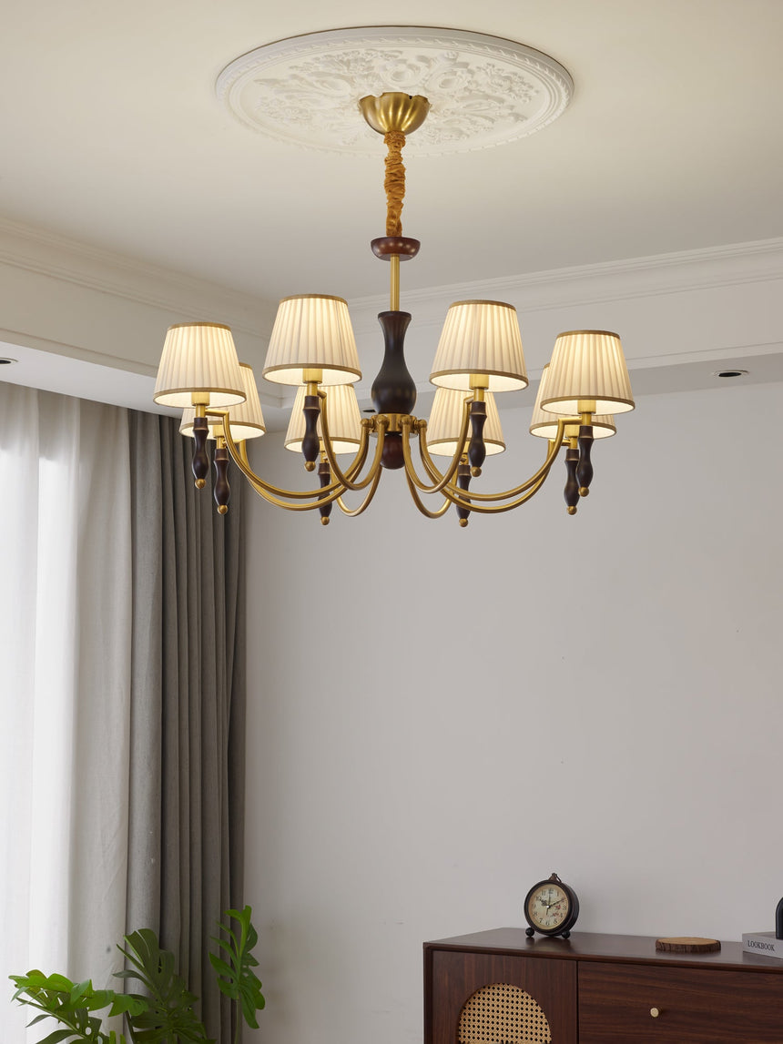 The pleated shades lit in a pale room above a chest of drawers