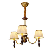 Three light chandelier with pleated shades on a walnut column