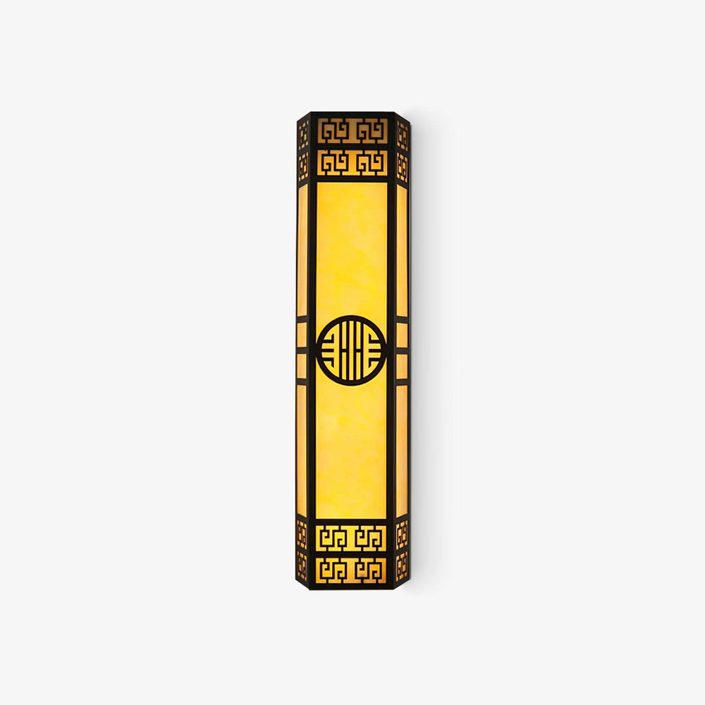 Tall black outdoor wall light with fretwork ends, a round medallion and glowing amber panels