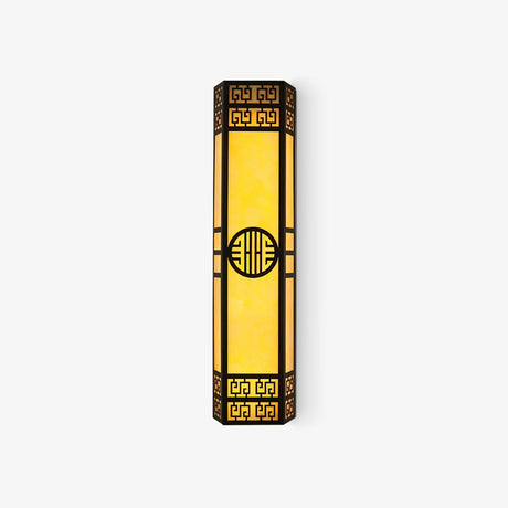 Tall black outdoor wall light with fretwork ends, a round medallion and glowing amber panels