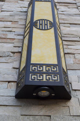 The underside of the column mounted on a stone wall, the bottom fitting visible