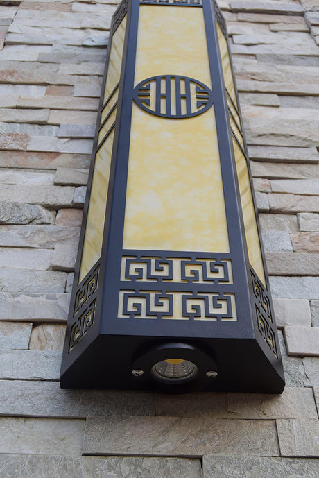 The underside of the column mounted on a stone wall, the bottom fitting visible
