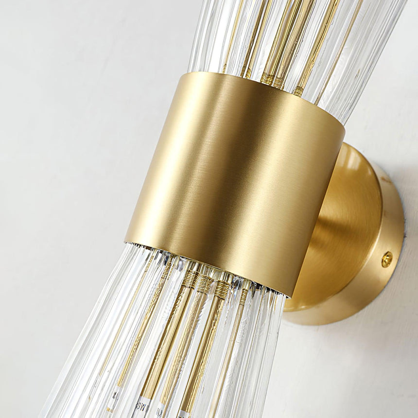 Close view of the gold cylinder, the round wall plate and the glass ribs
