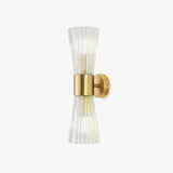 Wall sconce with a gold cylinder between two flared shades of ribbed clear glass