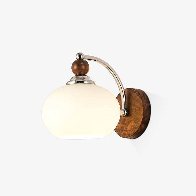 Transitional wall sconce, an opal dome on a curved arm and walnut plate