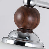 Close view of the walnut ball set on the chrome collar above the shade