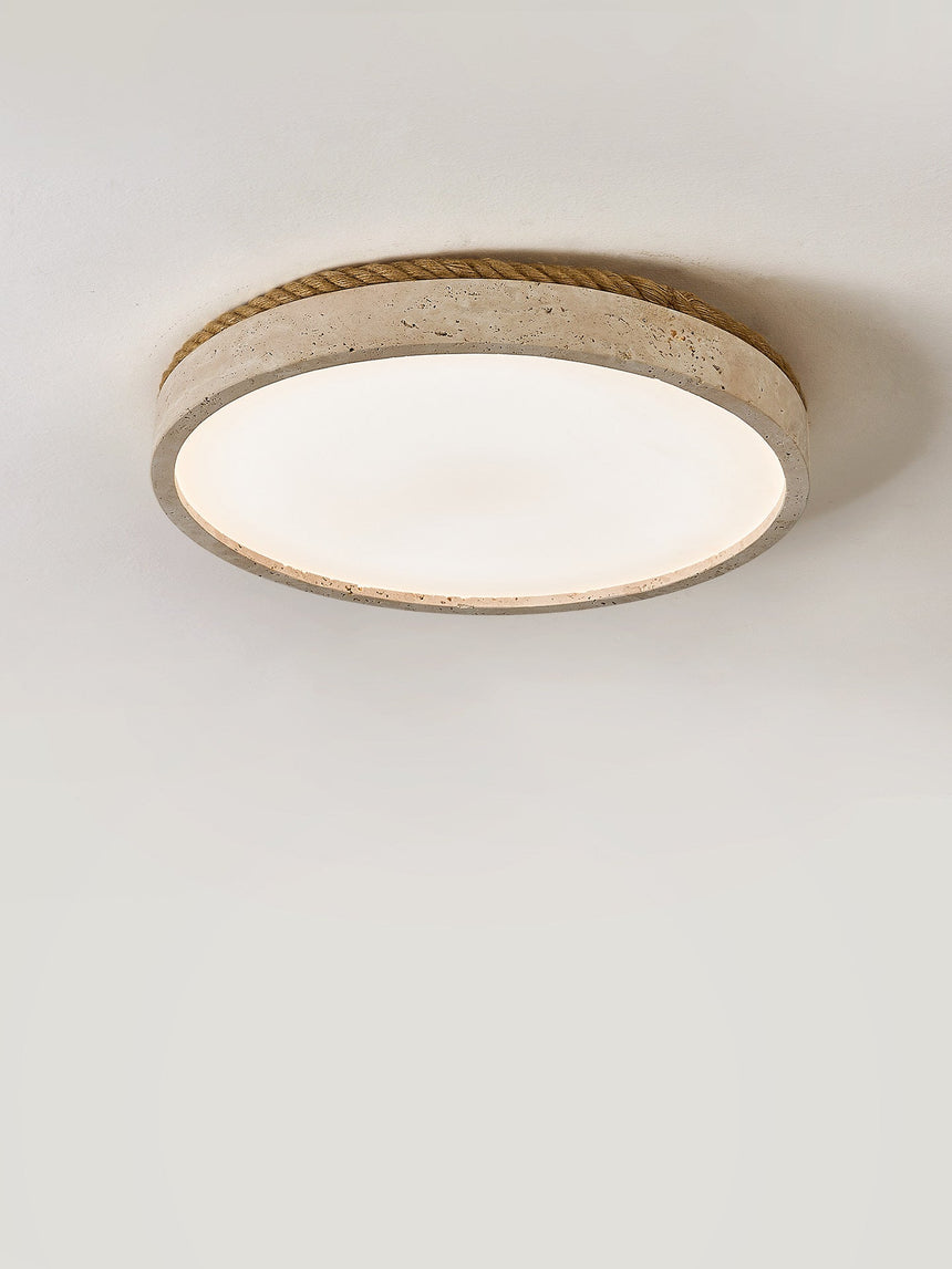 Round travertine ceiling light showing the stone rim around the lit panel