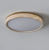Underside of the round travertine ceiling light with the panel unlit