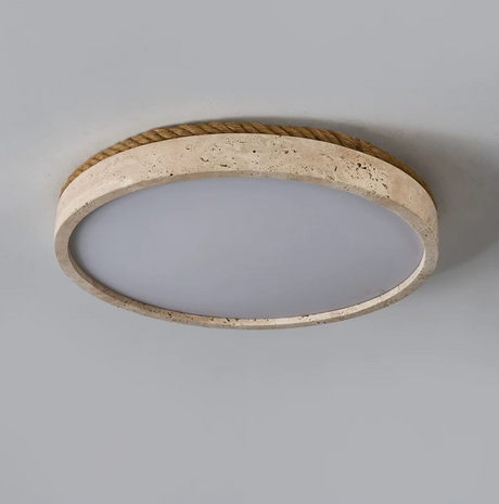 Underside of the round travertine ceiling light with the panel unlit
