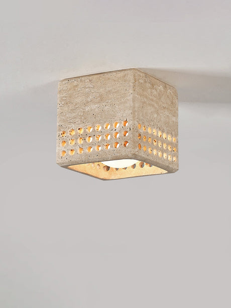 Square travertine block ceiling light mounted against a plain ceiling