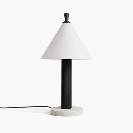 Travertine table lamp with a black fluted column seen from the front
