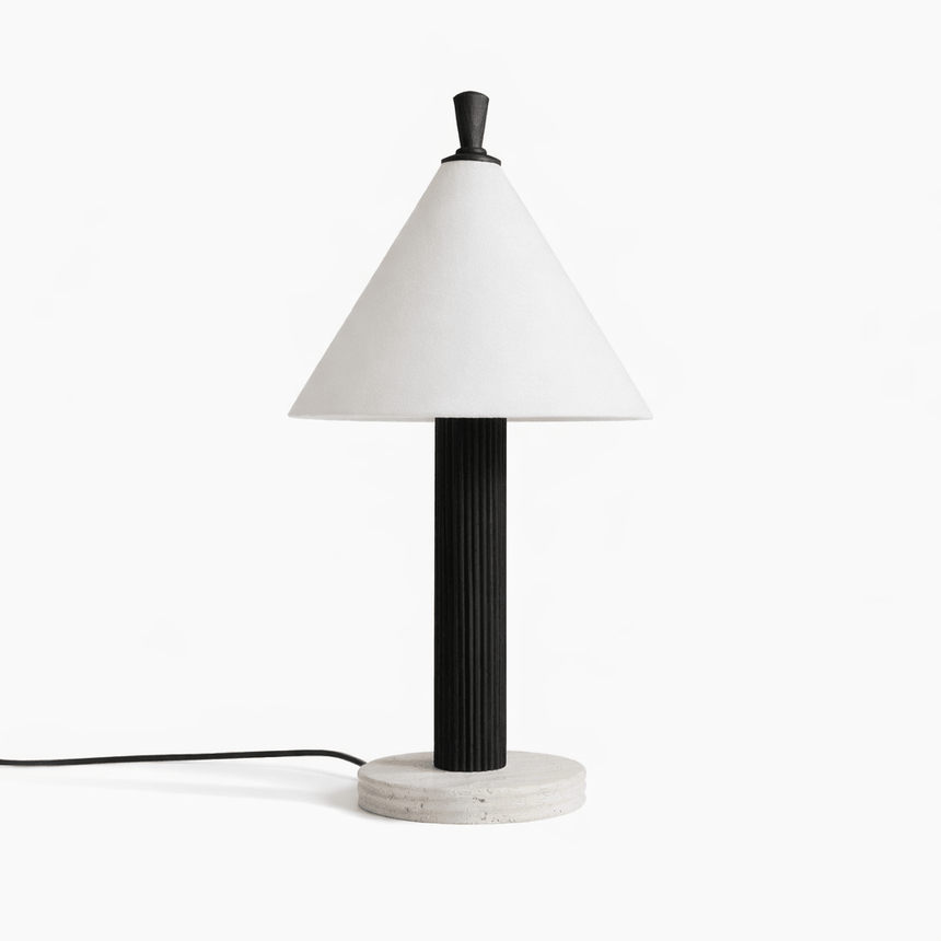 Travertine table lamp with a black fluted column seen from the front