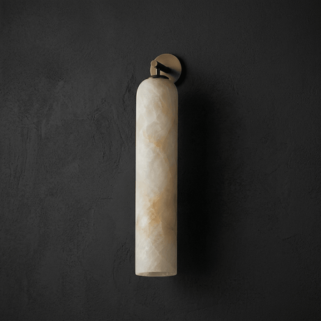The gold version glowing warm against a dark plaster wall